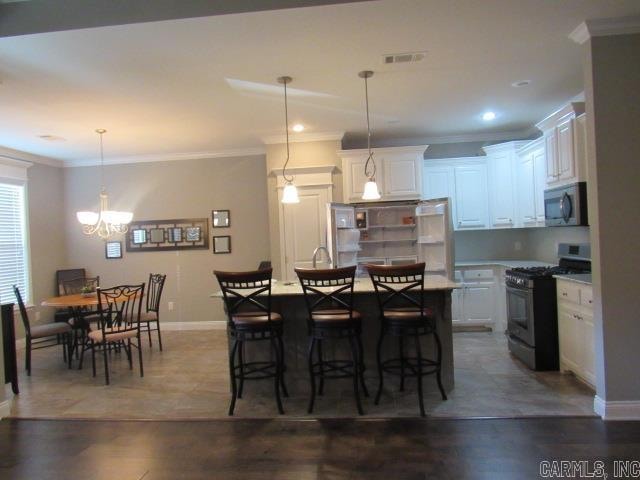 dining space featuring a chandelier, dark hardwood / wood-style flooring, and ornamental molding