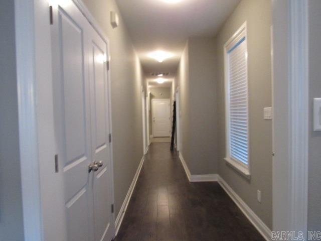 corridor featuring dark wood-type flooring