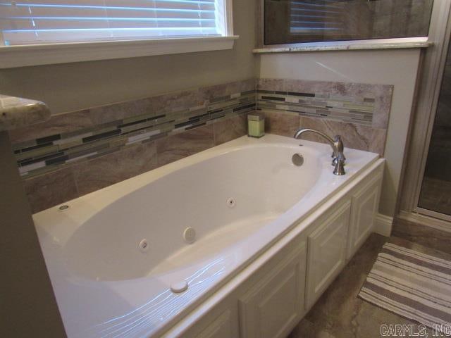 bathroom with separate shower and tub