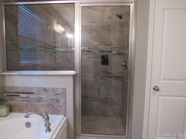 bathroom with separate shower and tub