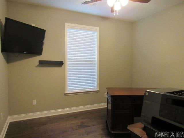 home office with ceiling fan and dark hardwood / wood-style flooring