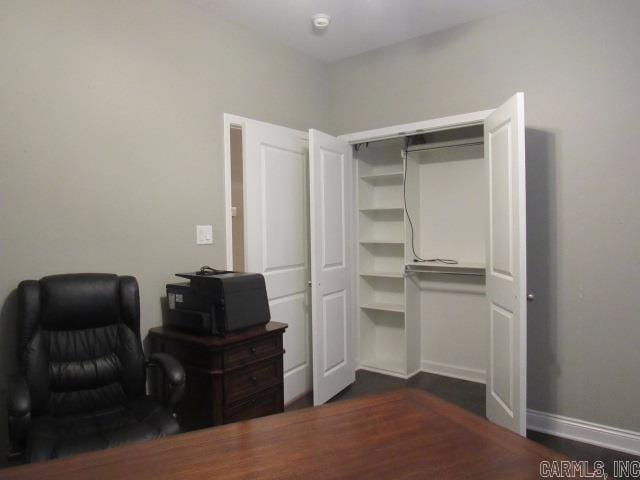 office with dark wood-type flooring