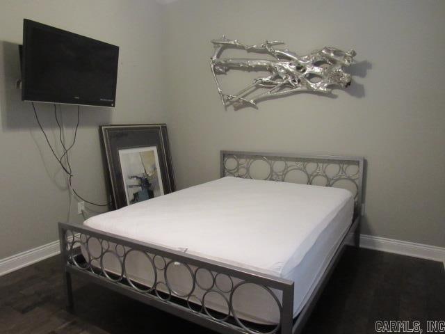 bedroom featuring dark hardwood / wood-style flooring