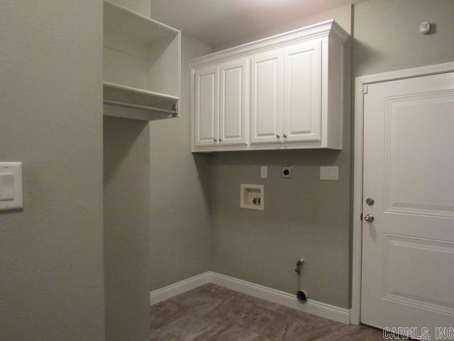 washroom with gas dryer hookup, cabinets, washer hookup, and hookup for an electric dryer