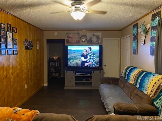 home theater room with dark hardwood / wood-style floors, ceiling fan, wooden walls, and a textured ceiling