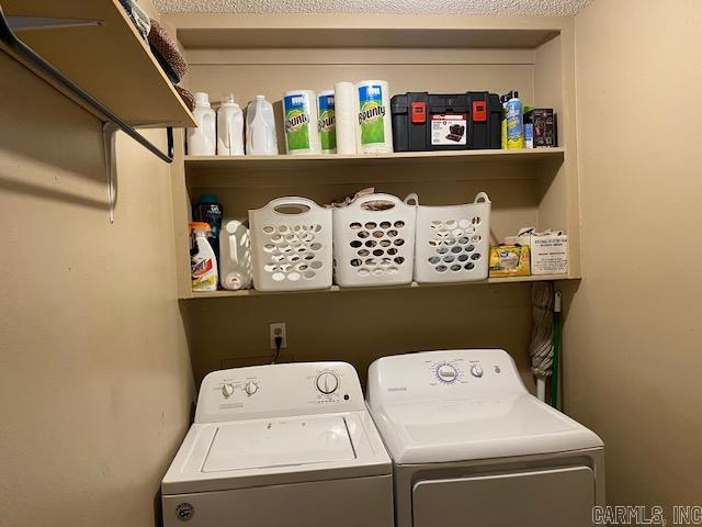 clothes washing area featuring separate washer and dryer