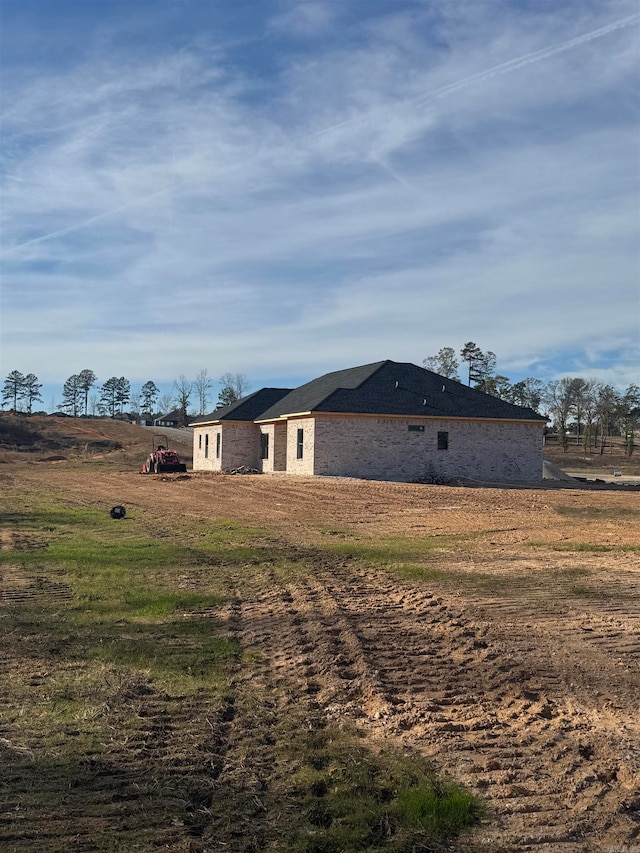 view of side of home featuring a lawn