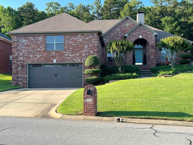 view of property with a garage and a front yard