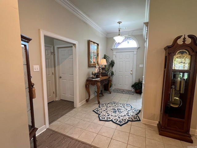 entrance foyer with light wood-type flooring and crown molding