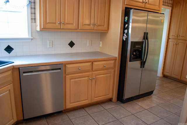 kitchen featuring stainless steel appliances, tasteful backsplash, and light tile patterned flooring