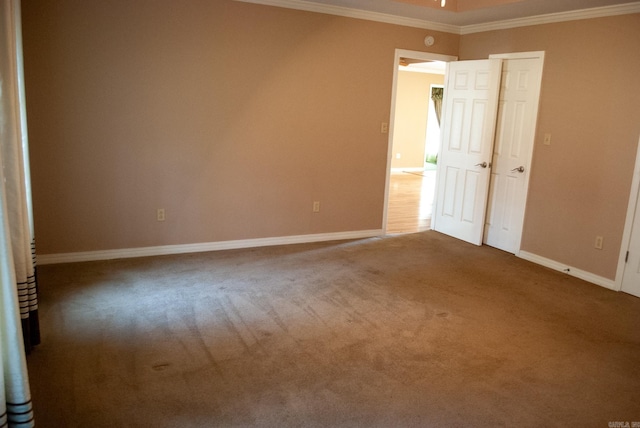 unfurnished bedroom with ornamental molding and carpet floors