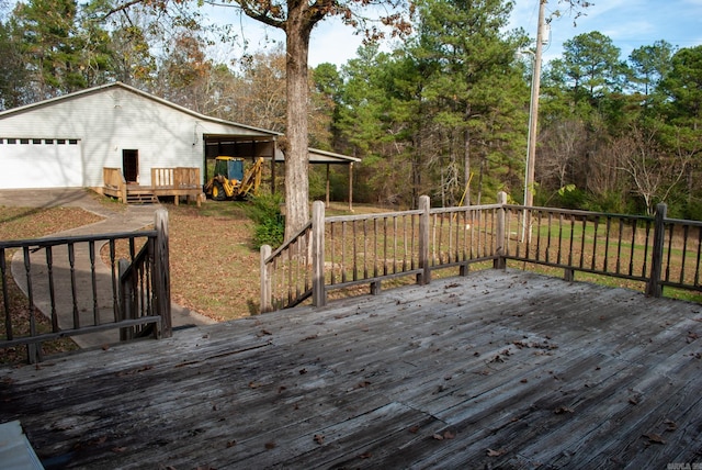 wooden deck with a garage and an outdoor structure