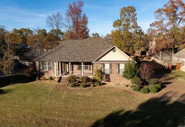 single story home featuring a front lawn and covered porch