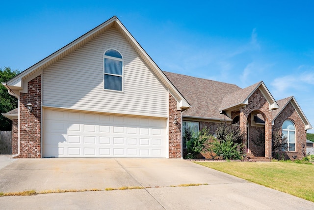 view of front of house featuring a garage and a front lawn