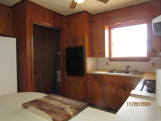 kitchen with ceiling fan, sink, tasteful backsplash, black oven, and stainless steel cooktop