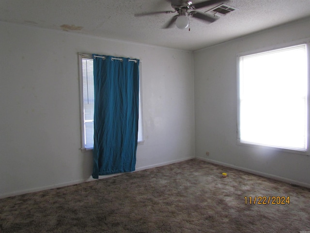 spare room with ceiling fan, carpet floors, and a textured ceiling