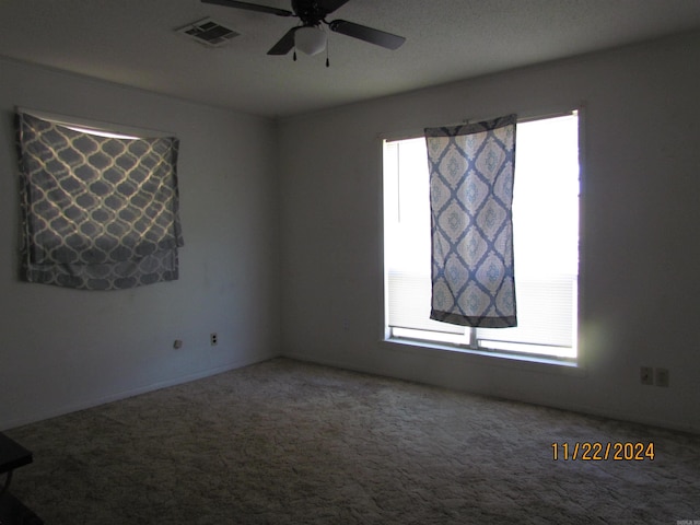 empty room with carpet flooring and ceiling fan