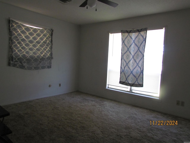 unfurnished room with ceiling fan and carpet floors