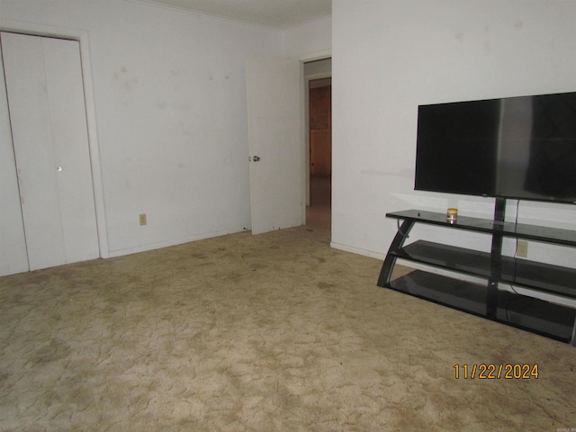 unfurnished living room featuring light colored carpet