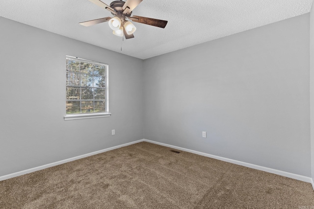 unfurnished room with carpet flooring, ceiling fan, and a textured ceiling