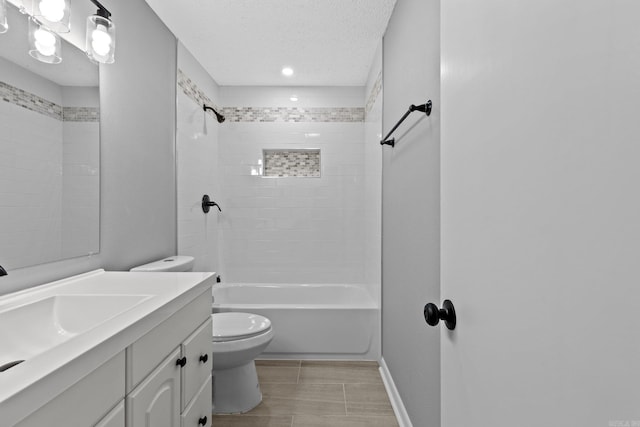 full bathroom with vanity, toilet, a textured ceiling, and tiled shower / bath