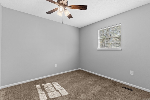 unfurnished room featuring a textured ceiling, carpet floors, and ceiling fan