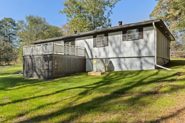 back of house featuring a yard and a deck