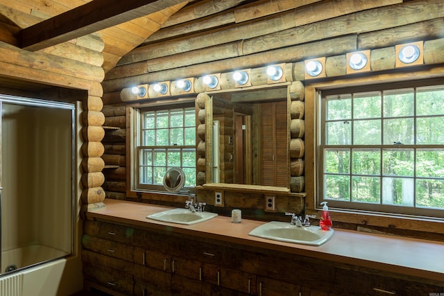 bathroom featuring beamed ceiling, vanity, enclosed tub / shower combo, and log walls