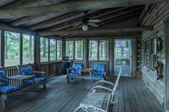 sunroom featuring vaulted ceiling with beams, ceiling fan, and wooden ceiling