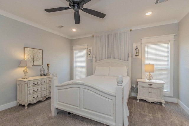 carpeted bedroom featuring ceiling fan and crown molding