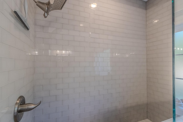 interior details featuring a tile shower