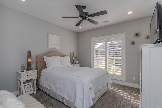 bedroom featuring ceiling fan and dark carpet