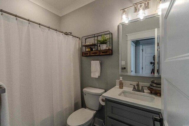 bathroom with a shower with curtain, vanity, toilet, and crown molding