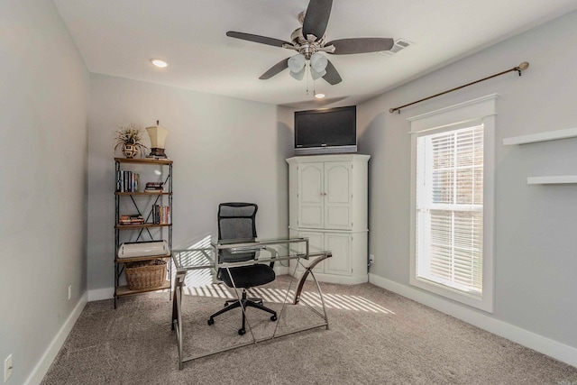 carpeted office space with ceiling fan