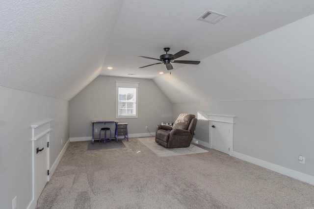 bonus room with a textured ceiling, ceiling fan, light colored carpet, and vaulted ceiling