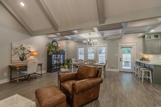 living room with beam ceiling, hardwood / wood-style floors, and a notable chandelier