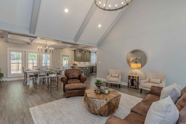 living room featuring beamed ceiling, a notable chandelier, and hardwood / wood-style flooring