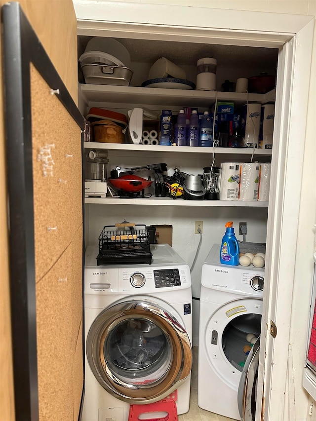 laundry room with washer and clothes dryer and tile patterned flooring