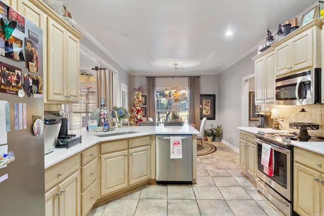 kitchen with a chandelier, plenty of natural light, stainless steel appliances, and sink