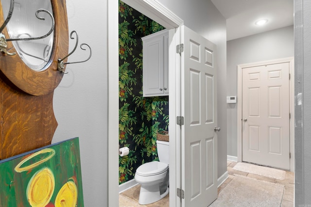 bathroom with tile patterned flooring and toilet