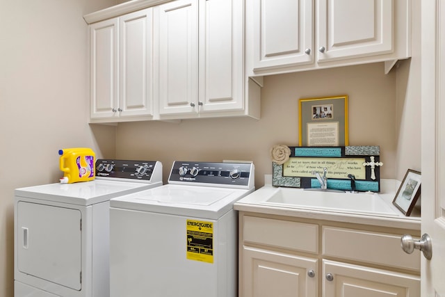 laundry room featuring washing machine and clothes dryer and cabinets