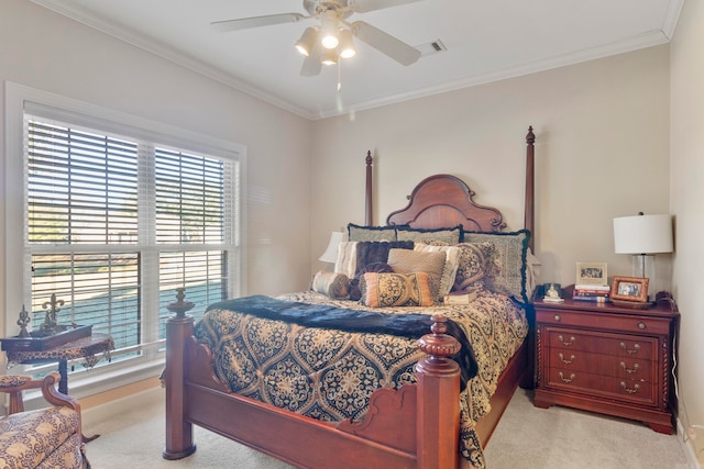 carpeted bedroom featuring ceiling fan and ornamental molding