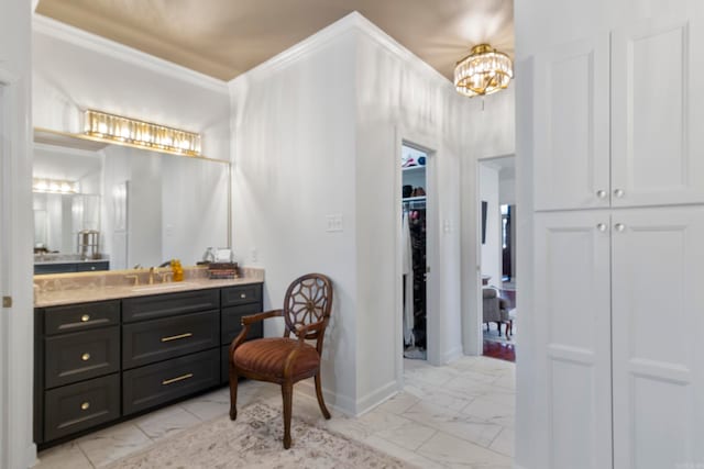 bathroom with a chandelier, vanity, and crown molding