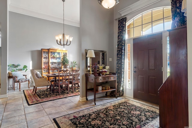 entrance foyer with a high ceiling, an inviting chandelier, and ornamental molding