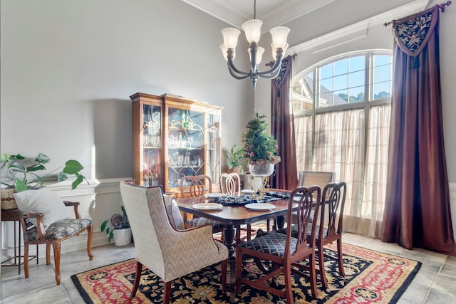 dining area featuring ornamental molding and an inviting chandelier