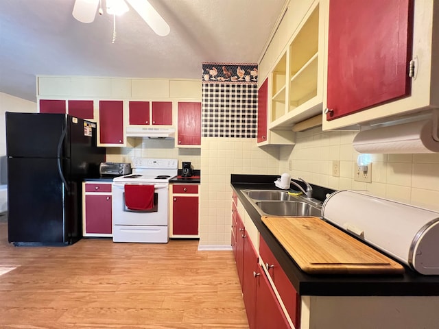 kitchen with black fridge, white electric range, sink, ceiling fan, and light hardwood / wood-style floors