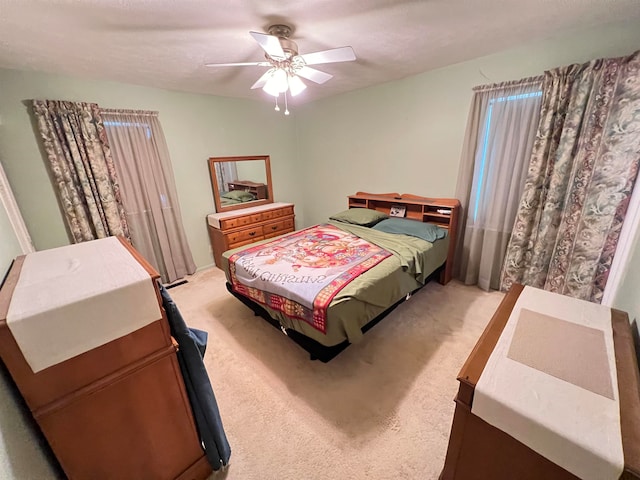 bedroom with ceiling fan and carpet