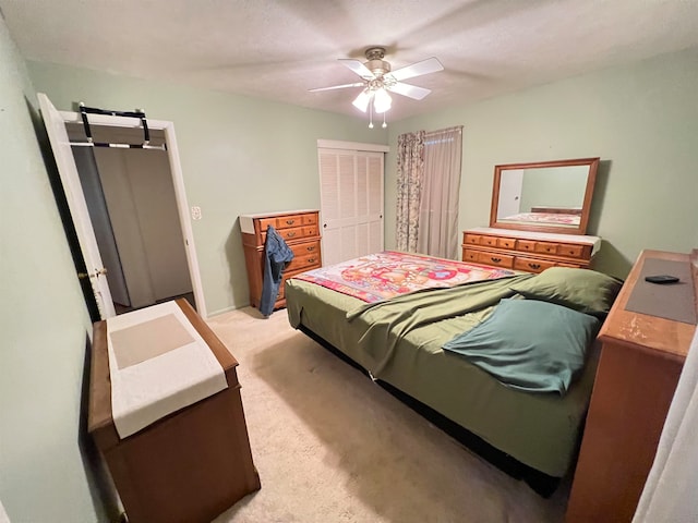 carpeted bedroom featuring a closet and ceiling fan