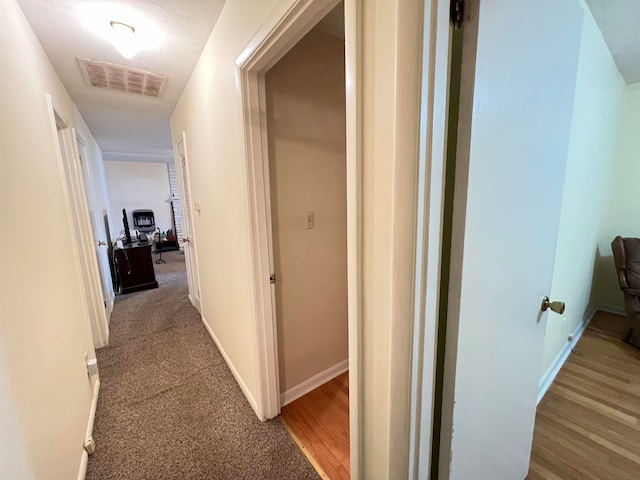 corridor with wood-type flooring