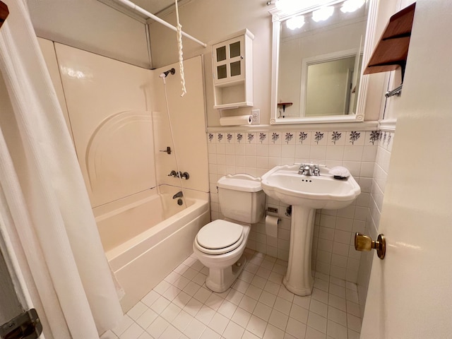 bathroom featuring tile patterned flooring, shower / bath combination with curtain, toilet, and tile walls